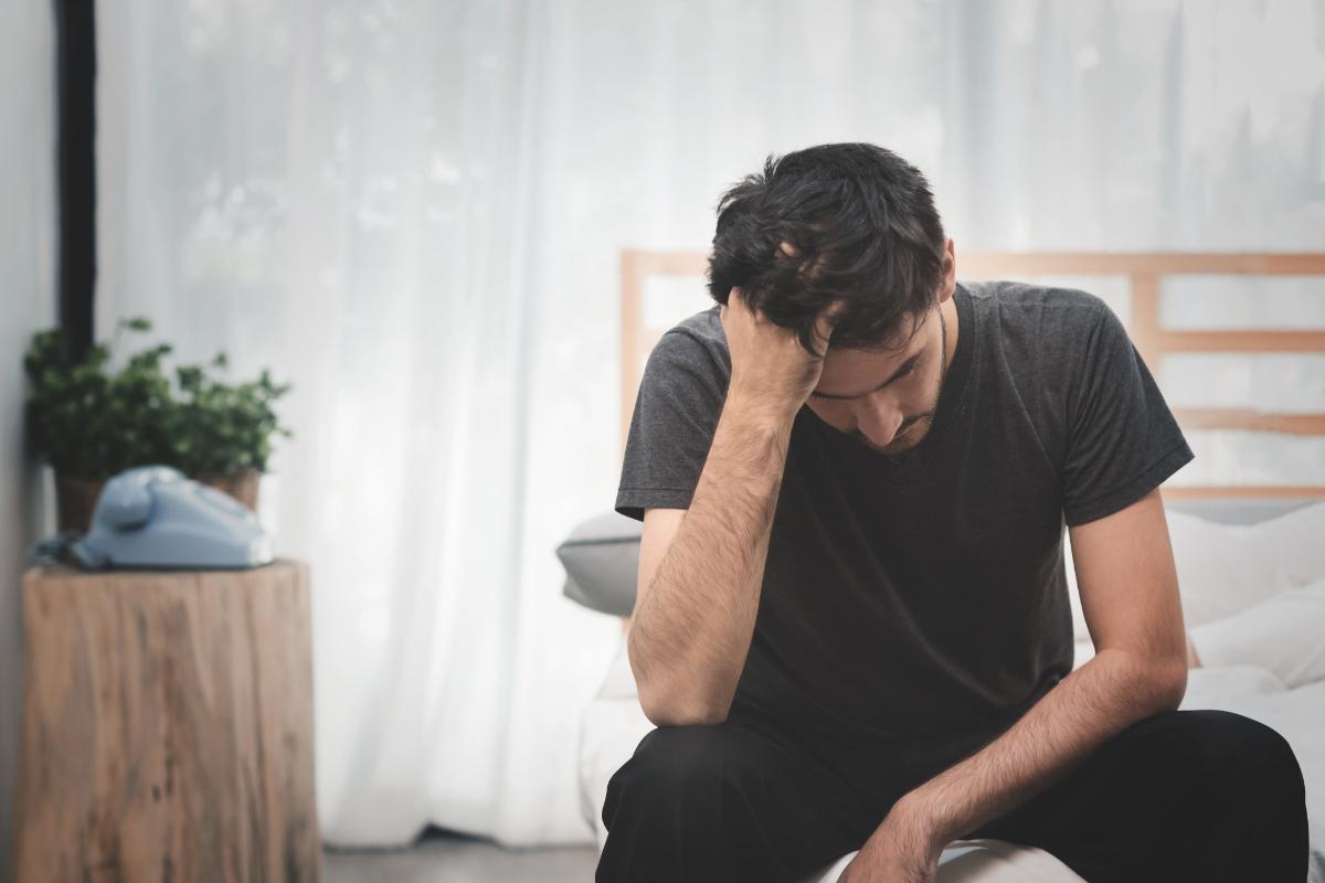 man deals with the common symptoms of taking crank