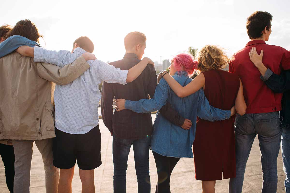 a group stands together to observe Alcohol and Drug Addiction Recovery Month