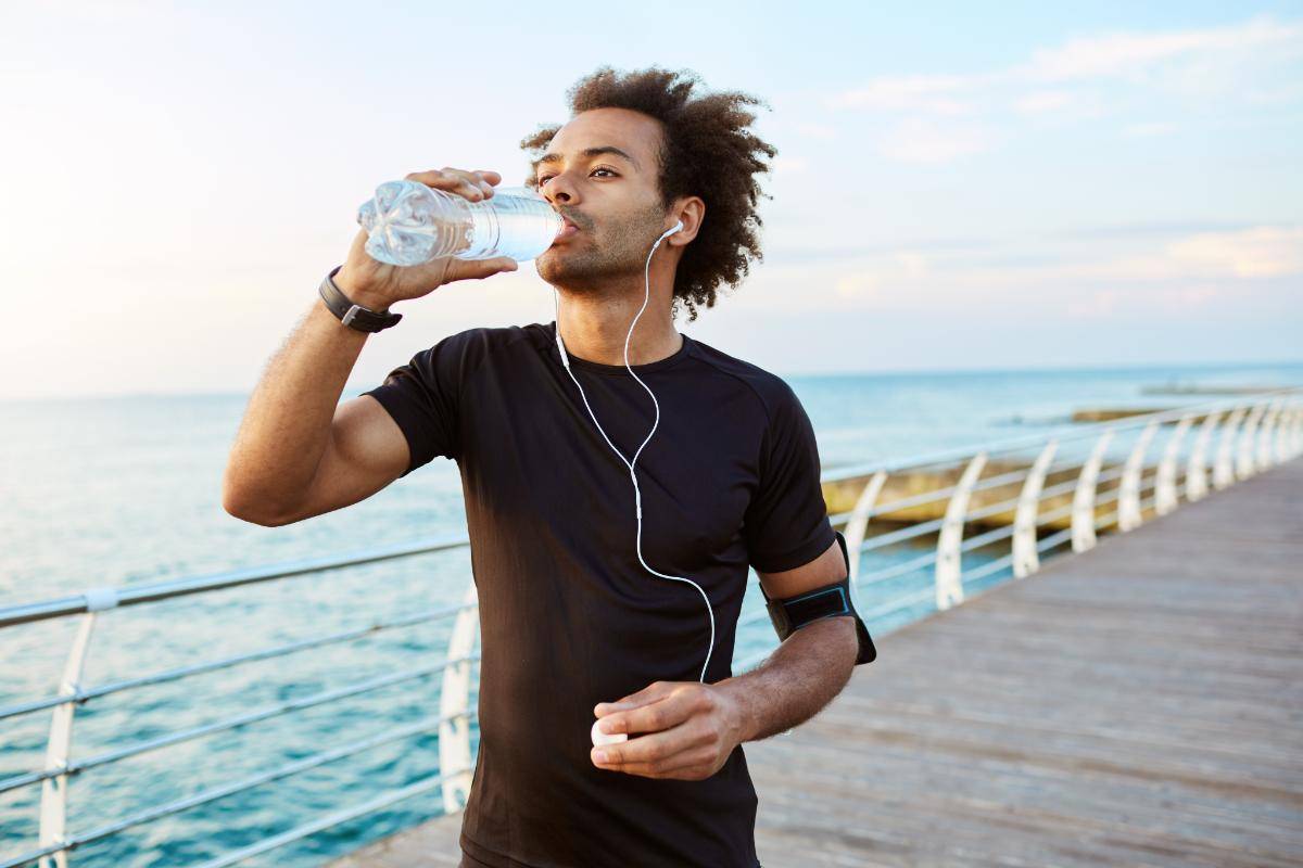 person drinking water after running to detox from THC